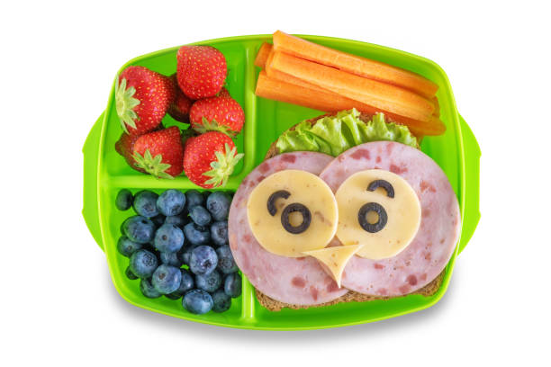 istock Kid's healthy breakfasts with funny faces in a container on a white isolated background 1334717916
