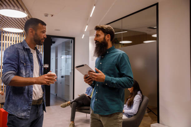 istock Two businessman standing in the office lobby, chatting 1334717947