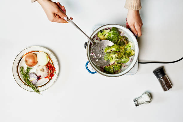 Preparing healthy food with organic vegetables. Cooking broccoli. Vegan food for weight loss