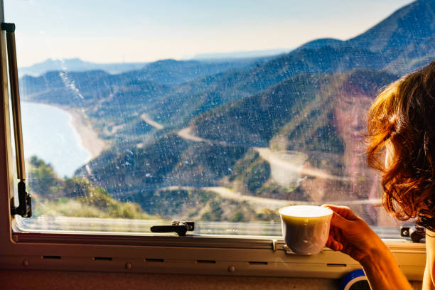 istock Woman in rv enjoy coast view, drinking coffee 1334718000