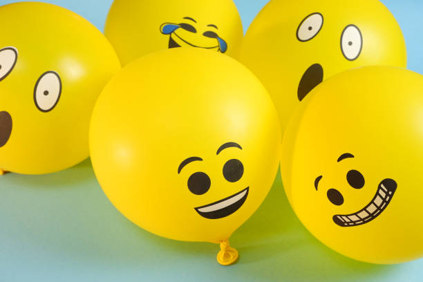 istock Yellow emoji balloons on a blue background. 1334724581