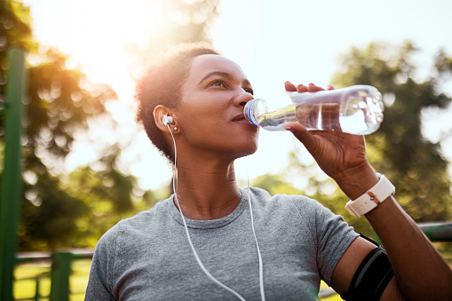 African American woman jogger hydrating