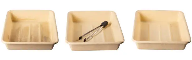 Plastic litter boxes used to store photographic chemicals. Darkroom accessories. Isolated background.