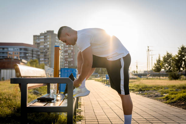 istock Young man exercising on the park bench 1334727063