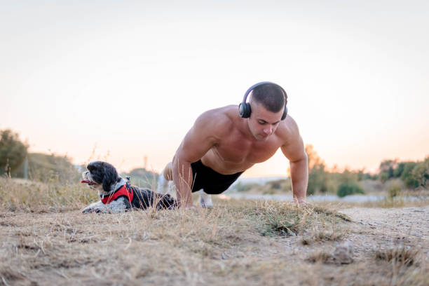 young man exercising with his dog - shirtless energy action effort imagens e fotografias de stock