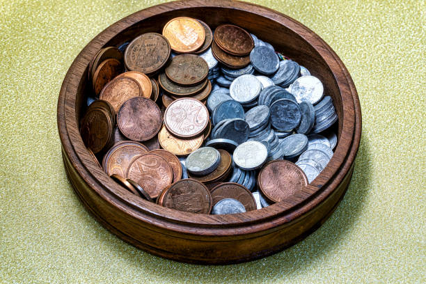 istock Wooden bowl with assorted cent coins 1334728428