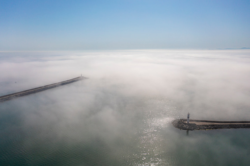 Entrance to port. Lighthouse in port of Samsun.  Fog over sea.