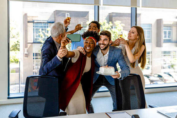 istock Friendly Multi-Ethnic Employees are Celebrating Birthday Together and Taking a Selfie. 1334733615