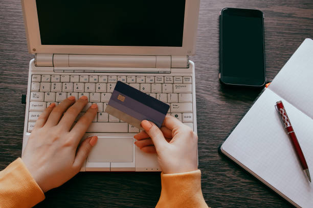 istock Woman doing online shopping on internet using laptop. Hands holding credit card. Discount and sale concept. 1334734044
