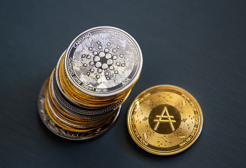 Antalya, Turkey - August 11, 2021: Close up shot of Bitcoin and alt coins cryptocurrency over brown background
