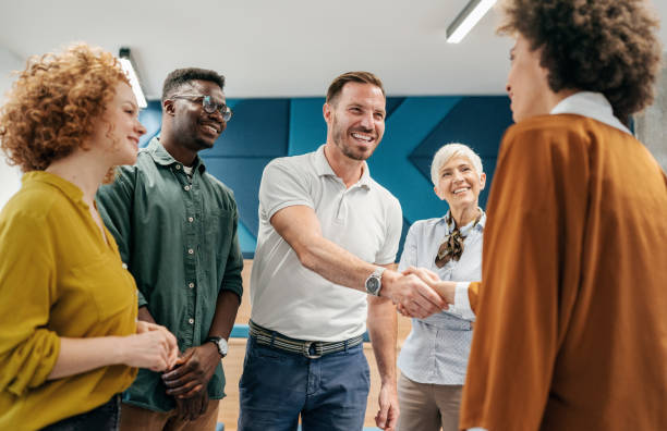 Handshake for the new agreement Happy businessman shaking hands with colleague on a meeting in the office. eastern european descent stock pictures, royalty-free photos & images