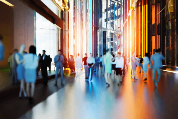 istock Business people walking in office building lobby 1334742312