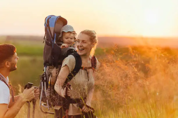 Photo of Happy Family Hiking With a Baby