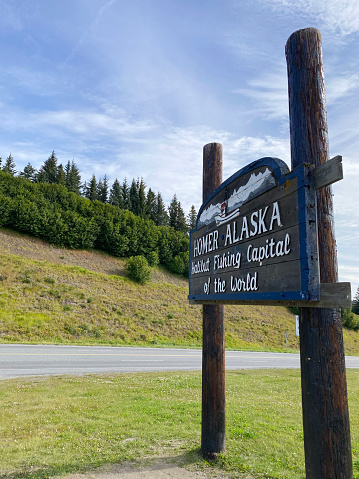 Homer, Alaska, USA - August 7, 2021: Homer Alaska Halibut Fishing Capital of the World sign along the Sterling Highway in Homer, Alaska.