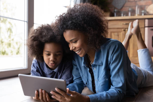 istock Happy ethnic mom and daughter use tablet together 1334745236