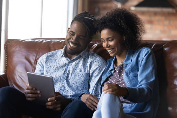 istock Happy ethnic couple talk on webcam call on tablet 1334745269