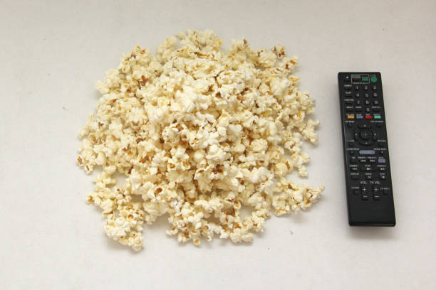 istock Freshly made natural popcorn ready for a movie on TV with drinks 1334745990