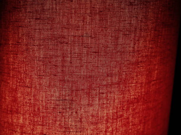 Red abstract background made of fabric. Macro image. Weaving tap-colored pits with black shadows and vignettes. Background for Christmas, New Year, Valentine's Day. Red abstract background made of fabric. Macro image. Weaving tap-colored pits with black shadows and vignettes. Background for Christmas, New Year, Valentine's Day. multi colored woven macro mesh stock pictures, royalty-free photos & images