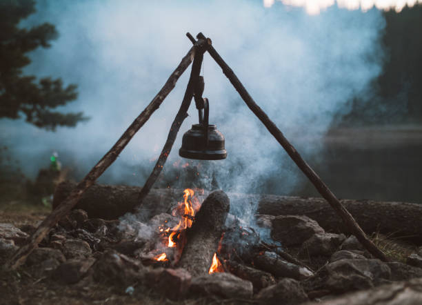 istock Campfire with a vintage teapot next to the lake 1334748523