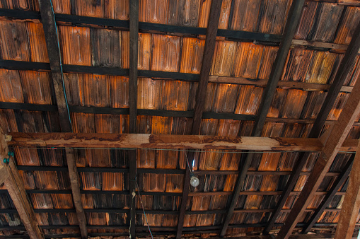inside a poor farmhouse looking at the ceiling