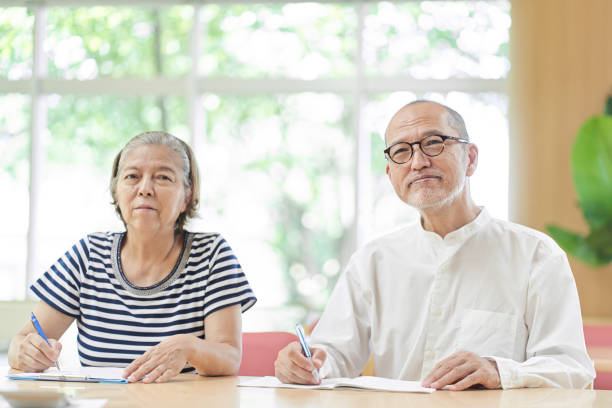 istock Elderly couple attending an inheritance seminar 1334759137