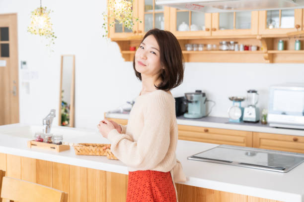 istock attractive asian woman relaxing,kitchen 1334763235