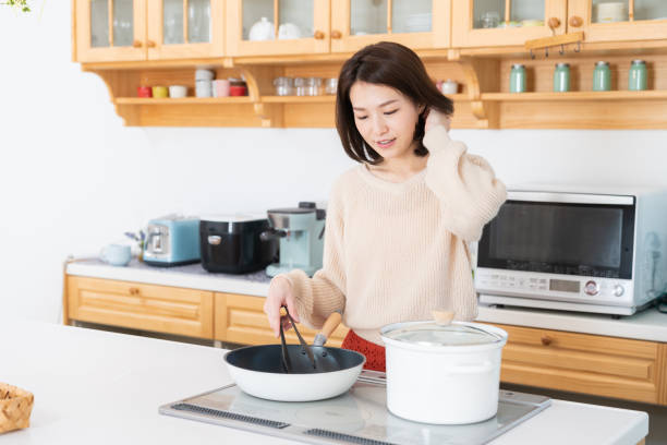 istock attractive asian woman cooks in a kitchen 1334763254