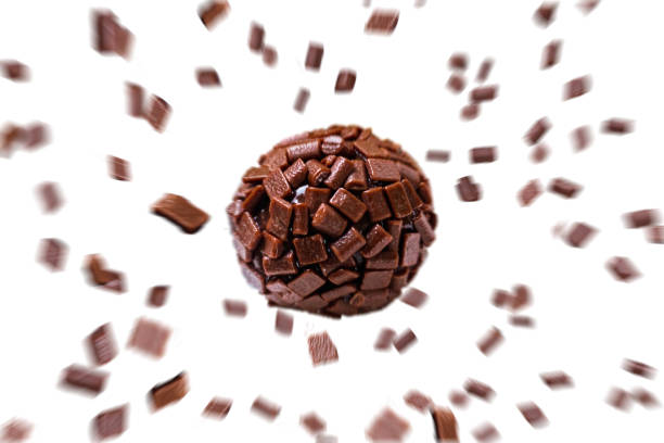 Brigadeiro, a traditional Brazilian sweet made with chocolate with sprinkles in zoom, on white background with space for text. The brigadeiro is a typical sweet of Brazilian cuisine, originating in Rio de Janeiro, which quickly spread throughout Brazil, making its presence in birthday parties common throughout the country. pick and mix stock pictures, royalty-free photos & images