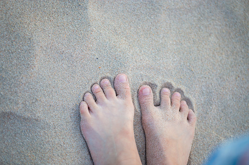 Close up of woman feet on the sand, People relaxing in summer, Travel and freedom concepts