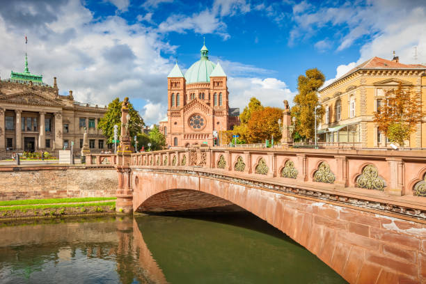 Canal with bridge and Saint Pierre Le Jeune church in central Strasbourg, Alsace, France.