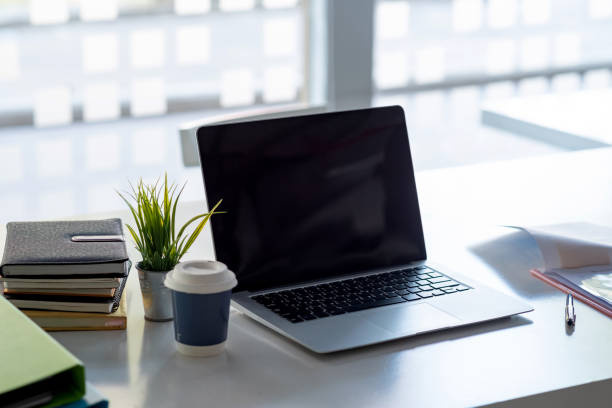 istock Image of laptop computer and a coffee mug placed on the desk. 1334765041