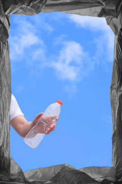 istock View from below of young man hand throwing plastic water bottle into outdoors trash bin 1334765310