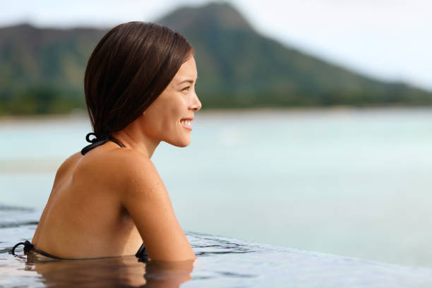 istock Vacation woman swimming at infinity pool on Hawaii 1334772280