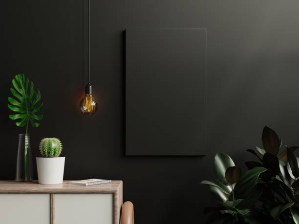 istock Mockup black poster in living room interior on empty dark wall background. 1334772875
