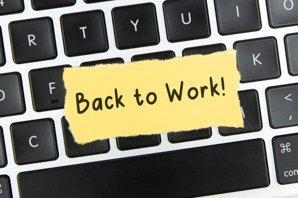 istock Text Back to Work on torn paper on top of laptop keyboard 1334772885