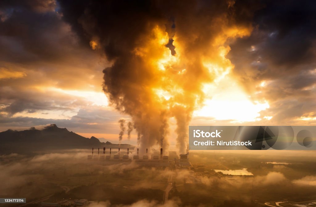 coal power plant and fog. Aerial view coal power plant station in the morning mist, the morning sun rises. coal power plant and environment concept. Coal and steam. Mae Moh, Lampang, Thailand. Fossil Fuel Stock Photo