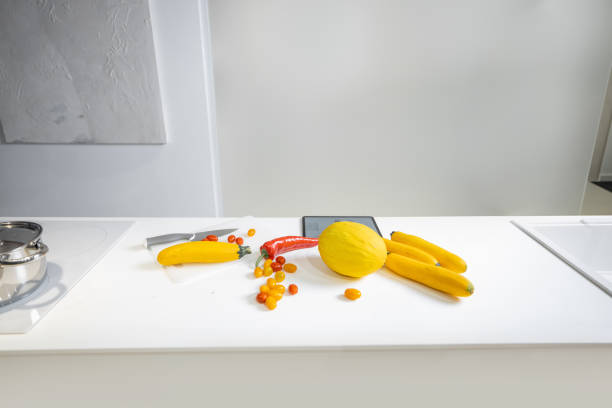 Healthy food ingredients on the table at kitchen. Raw yellow fruits and vegetables ready to cook