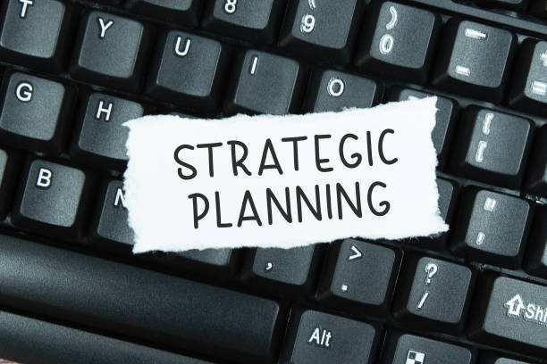 istock Text Strategic Planning on torn paper on top of laptop keyboard 1334775588