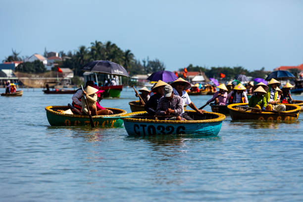 Tourist in the Basket Boats of Hoi An in Vietnam Hoi An, Quang Nam, Vietnam - December 13, 2019: Tourist in the Basket Boats of Hoi An in Vietnam basket boat stock pictures, royalty-free photos & images
