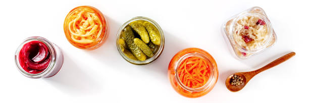 Fermented food panorama on a white background. Canned vegetables Fermented food panorama on a white background. Canned vegetables. Pickles, sauerkraut and other organic preserves in glass jars. Healthy vegan cooking concept fermenting photos stock pictures, royalty-free photos & images