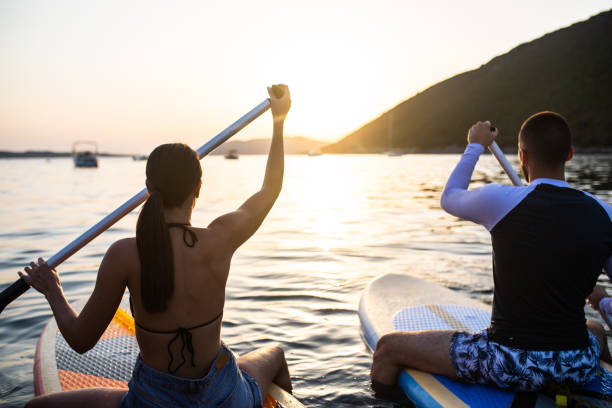 istock A couple on active holiday enjoying the sunset while standup boarding 1334782130
