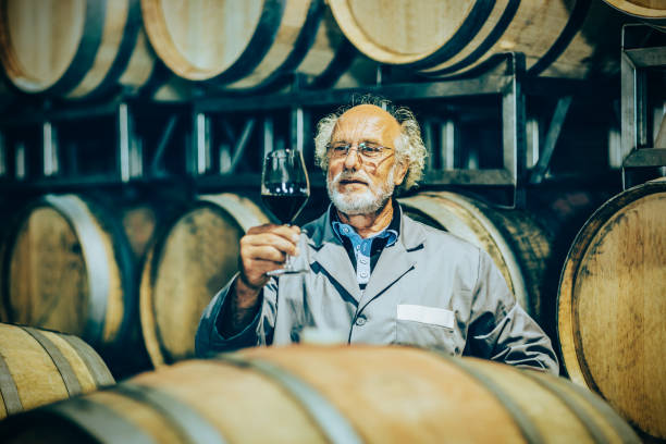istock Senior man winegrower is checking the red wine quality 1334782448