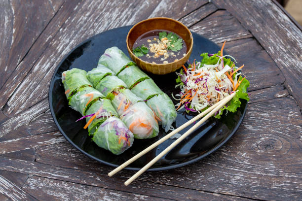 istock Fresh vietnamese spring rolls on a plate with salad 1334785233