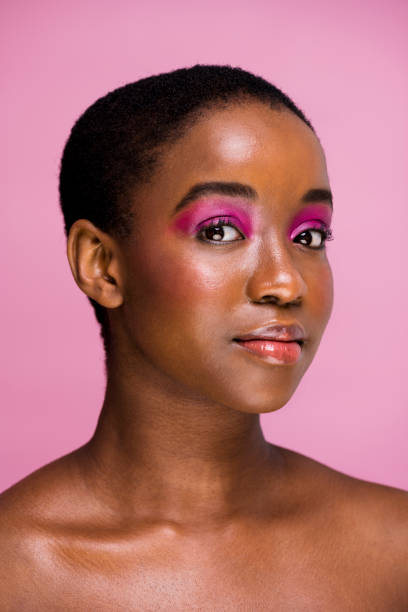 istock Beautiful African woman posing with bright pink makeup 1334785346