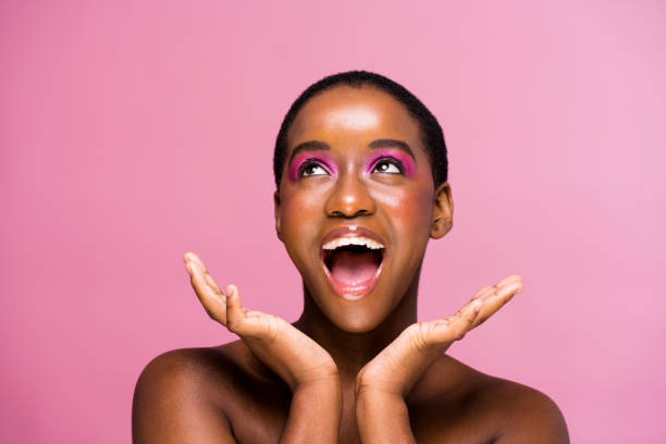 Portrait of happy young woman cheering in excitement