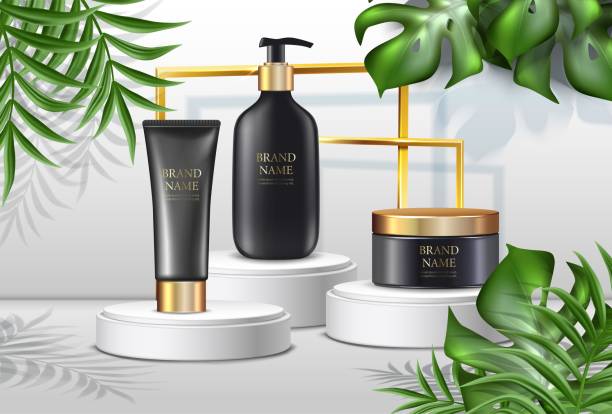 istock summer cosmetics background, advertisement with palms ans black cream bottles with golden lids and sunshine spots and golden frame on white stand. 1334787632