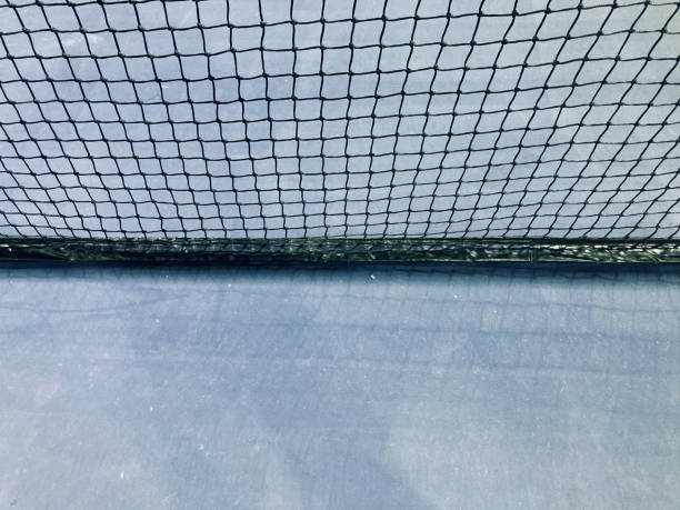 istock black nylon tennis net and light blue court 1334788312