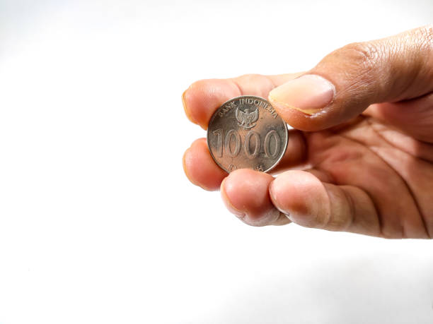 istock hands that hold coins with white backgrounds 1334789356