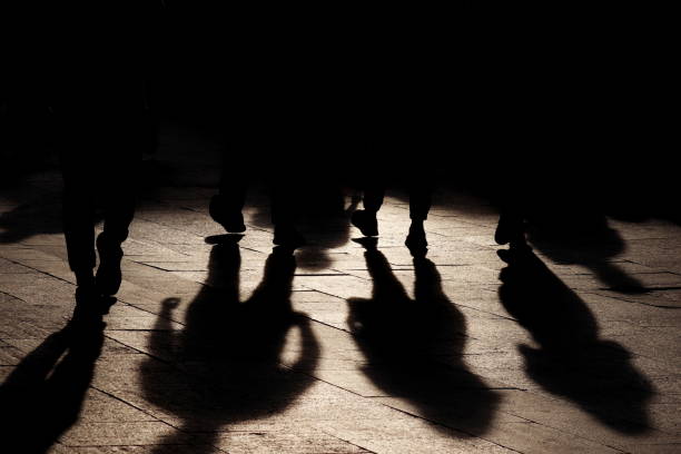 Black shadows and silhouettes of people on the street Crowd walking down on sidewalk, concept of pedestrians, crime, society, population gang photos stock pictures, royalty-free photos & images
