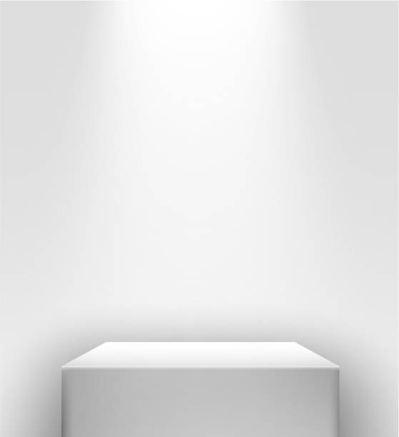 istock 3d realistic white presentation stand with spot light in front of a white wall. 1334790570
